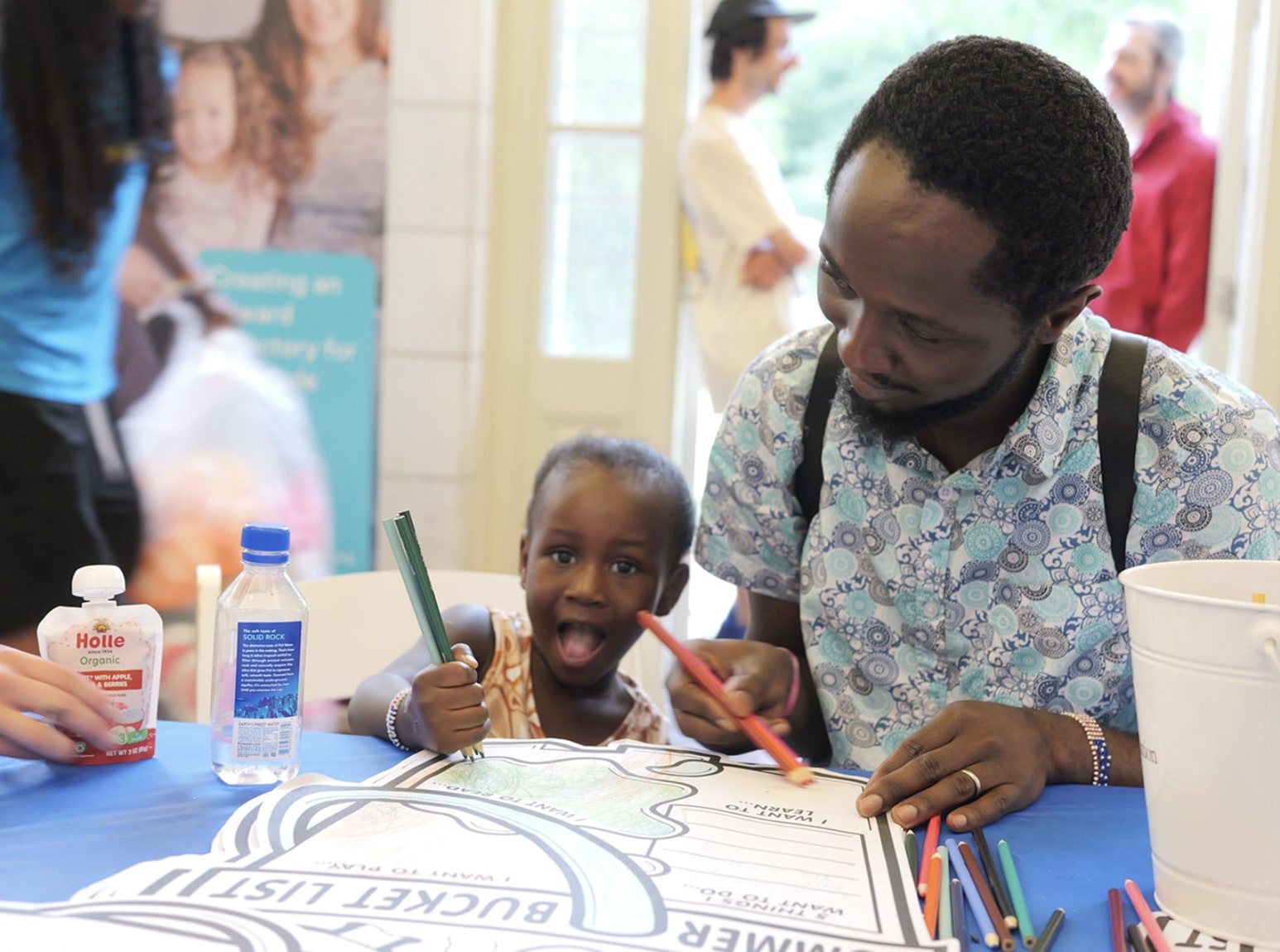 a Good+Foundation event where a child and adult are coloring together